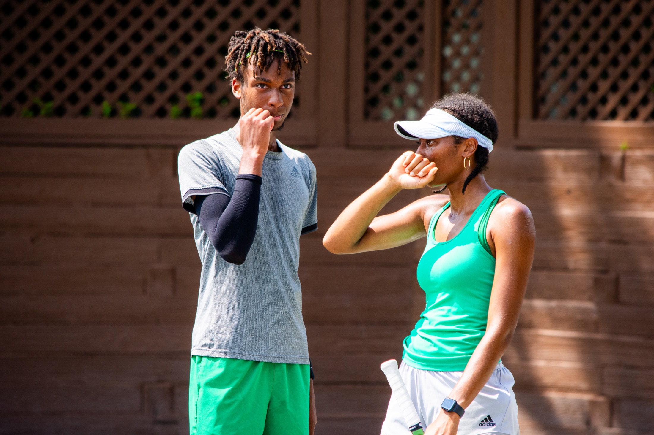 Mixed doubles partners talking together between tournament points