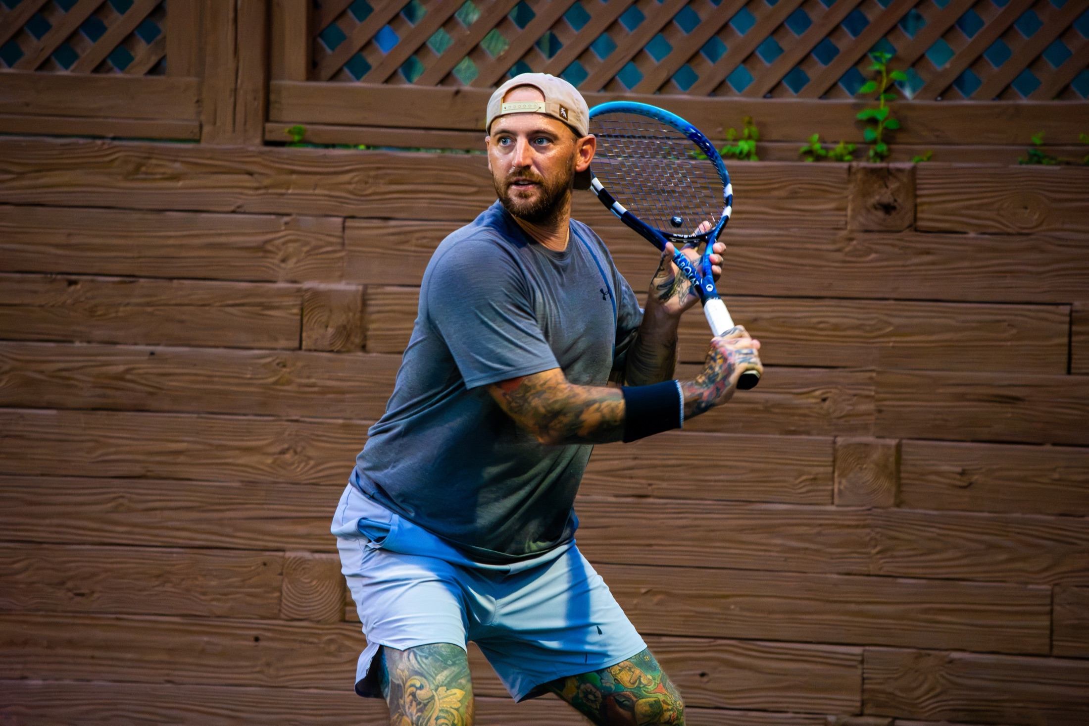 Tennis player preparing a two-handed return during tournament play