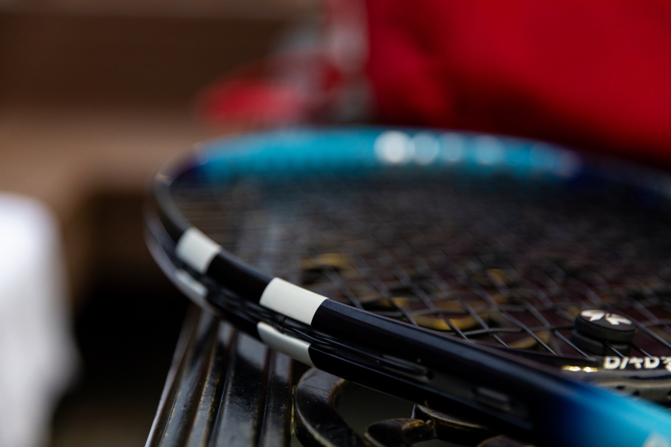 Close detail of tournament tennis rackets resting courtside