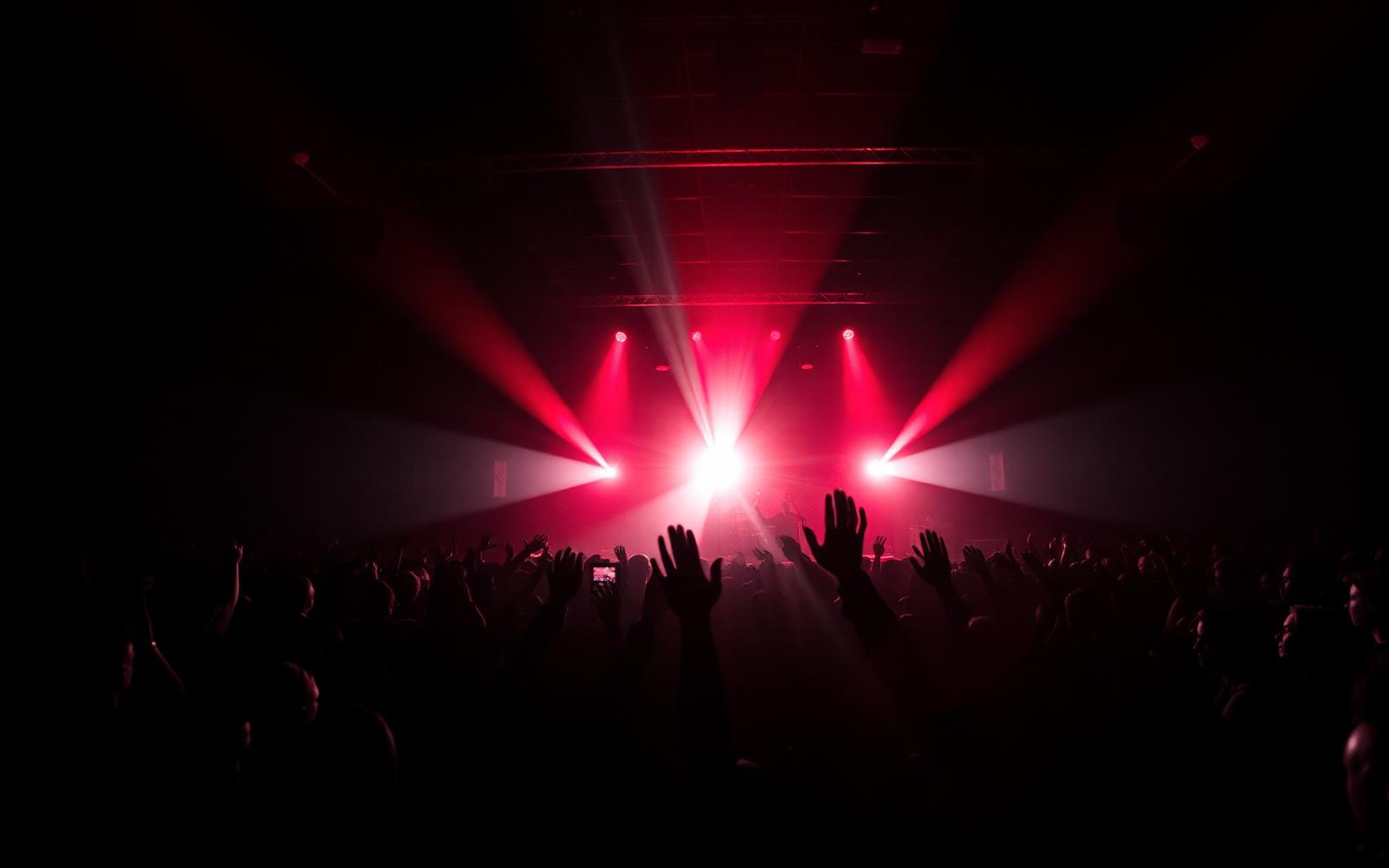 Concert crowd bathed in red stage light